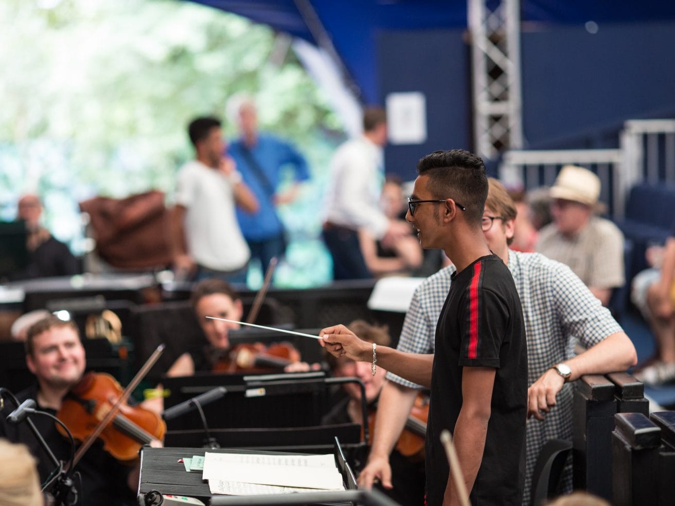 One of the Refuge in Harmony participants at the Opera Holland Park conductors' podium, conducting the City of London Sinfonia.